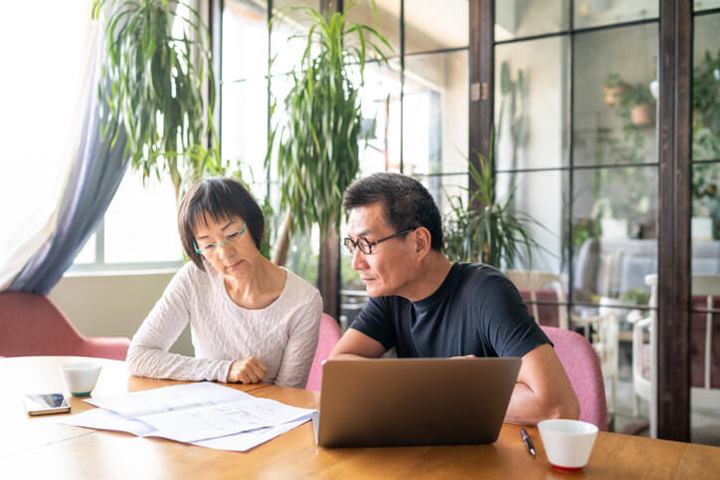 Older couple reviewing house finances on their computer